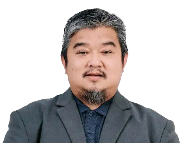 A man with salt-and-pepper hair and a goatee is wearing a dark suit jacket over a black shirt, facing the camera against a plain white background. CK Media